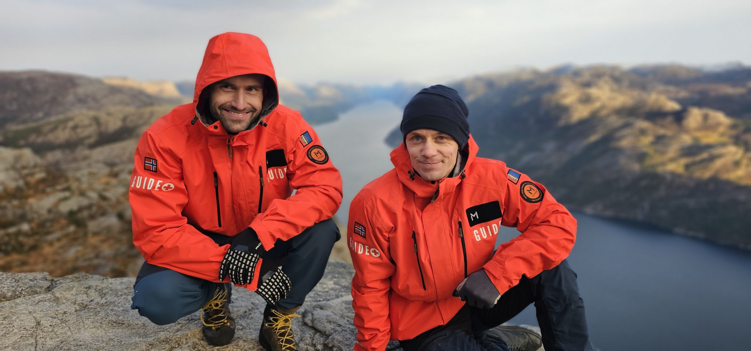 TrollAdventure guides leading a winter hiking group on the Pulpit Rock route near Stavanger, Norway