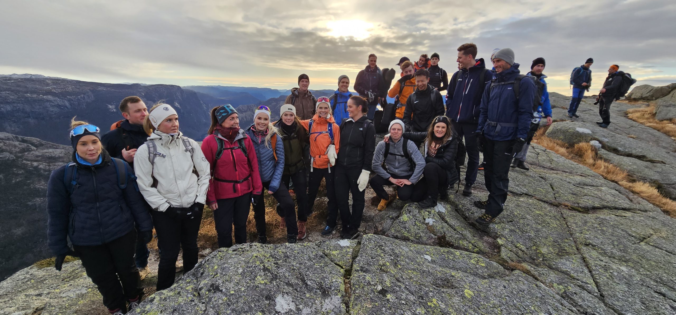 Corporate group gathered in the mountains during a guided Pulpit Rock hiking experience from Stavanger, Norway