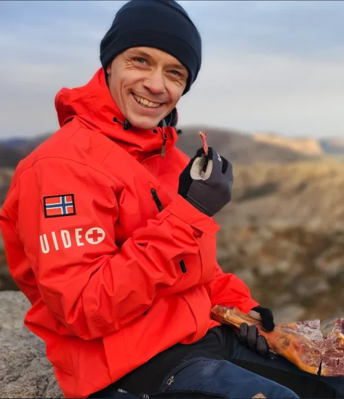 Jonas, guide and firefighter, at the top of Pulpit Rock with a cured leg of lamb